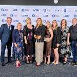 This photo depicts a staff team photo against the LCBU photo wall.