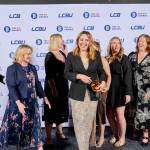 This photo depicts a staff team photo against the LCBU photo wall.