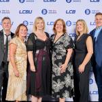 This photo depicts a staff team photo against the LCBU photo wall.