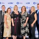This photo depicts a staff team photo against the LCBU photo wall.