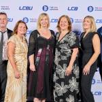 This photo depicts a staff team photo against the LCBU photo wall.