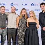 This photo depicts a staff team photo against the LCBU photo wall.
