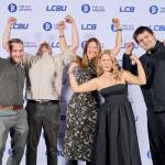 This photo depicts a staff team photo against the LCBU photo wall.