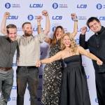 This photo depicts a staff team photo against the LCBU photo wall.