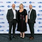 This photo depicts a staff team photo against the LCBU photo wall.