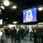 This photo depicts guests socialising as well as one of the events large digital presentation screens.