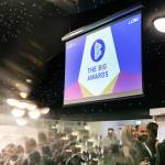 This photo depicts guests socialising as well as one of the events large digital presentation screens.
