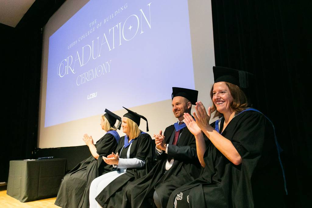 LCBU staff applauding students.