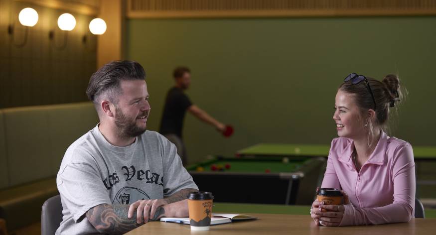 This image depicts an LCB student talking to a member of staff in the North Street Enrichment room.